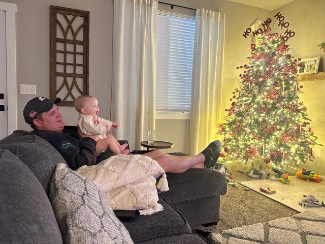 Jason Newton and son at Christmas – reading and quiet time